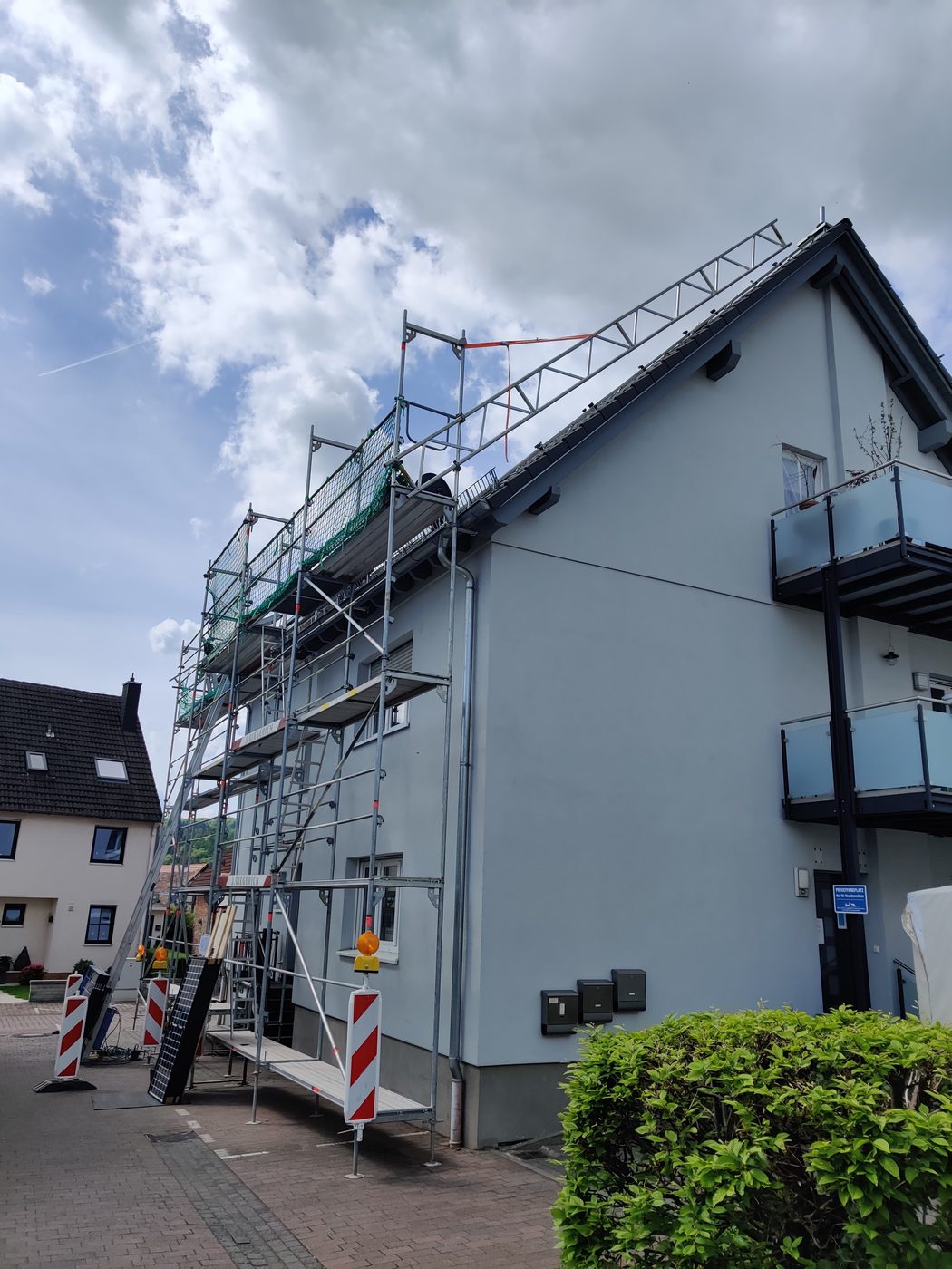 Gebäude mit Gerüst während der Photovoltaik-Montage